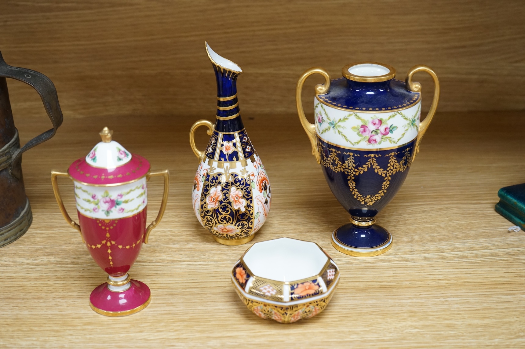 A Royal Crown Derby Imari miniature bowl and similar ewer, together with two Minton two handled vases, one with a cover, 18cm